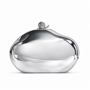 Detailed view of silver pebble evening bag with polished finish and snail-shaped clasp