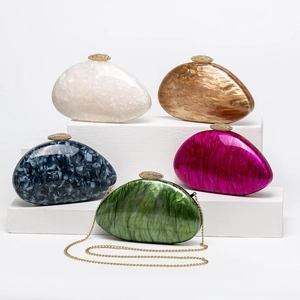 Close-up of marble textured acrylic shell evening bags in five colors with diamond clasps
