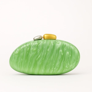 Detail of green marble texture clutch bag with gold and silver pebble-shaped metal clasps