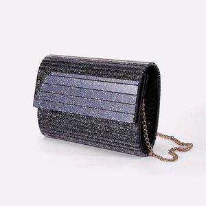 Sparkly black and silver striped evening clutch bag with a golden chain shoulder strap
