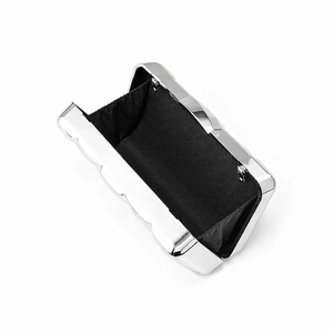 Internal view of silver acrylic evening bag with black lining and wavy metallic edge