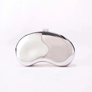 Detailed close-up of a bean-shaped silver metallic clutch with a polished mirror finish