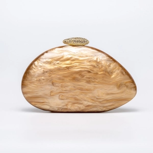 Detailed close-up of marble texture acrylic shell clutch with gold beaded metal clasp
