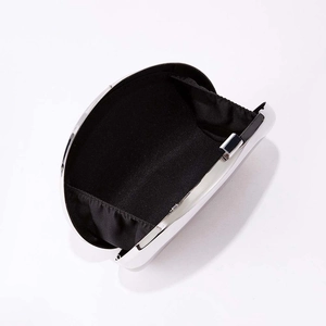 White hard shell evening clutch bag with silver metal frame and black fabric lining