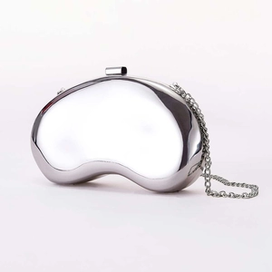 Modern bean-shaped silver metal clutch bag with mirror finish and delicate chain strap