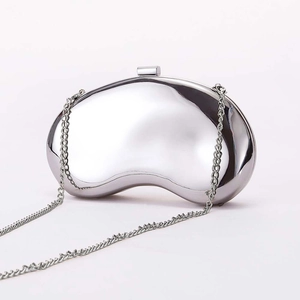 Minimalist silver mirror metal bean clutch bag with sleek chain strap for evening wear