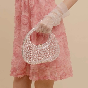 Elegant clear acrylic handbag with white pearl filling and metallic clasp for parties