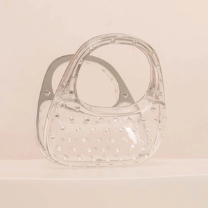Transparent acrylic handbag with silver crystal accents and curved handle for evening events