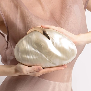 Detail of mother of pearl texture acrylic evening clutch bag with rose gold metal clasp