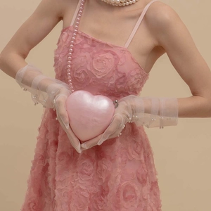 Pink heart-shaped acrylic evening clutch bag with pearl luster finish and beaded strap