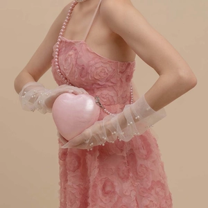 Pink heart-shaped acrylic evening clutch bag with pearl chain strap and marble texture