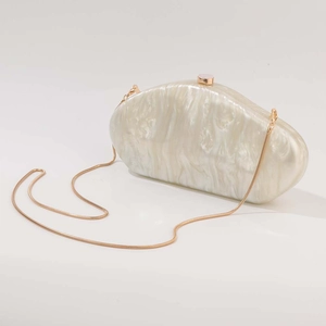 White pearlescent marble acrylic clutch bag with gold chain strap for evening events