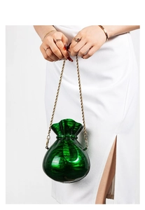 Close-up of emerald green marble texture acrylic bag with elegant gold woven chain