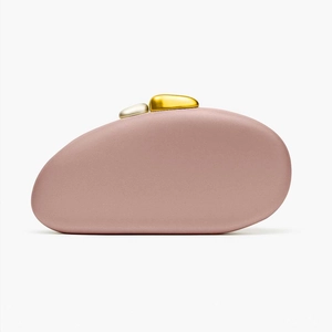 Detailed view of matte lavender pebble-shaped clutch with gold and silver stone clasp