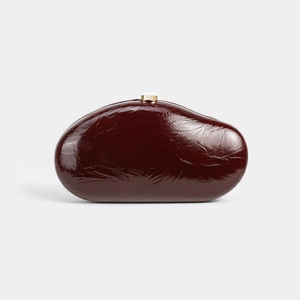 Artistic dark burgundy pebble clutch in glossy patent leather with a gold metal top clasp