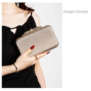 Close-up of champagne rhinestone clutch bag with crystal bow clasp held by a model