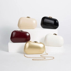Detail of five PU leather clutch bags in assorted colors with gold metal clasps and chain