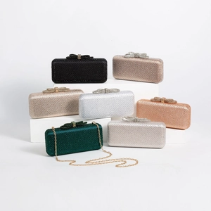 Detailed view of colorful rhinestone clutch bags with crystal bow clasps and gold chains