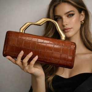 Brown crocodile embossed evening clutch with unique gold streamlined metal handle