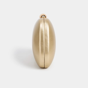 Detail view of champagne gold evening clutch with textured PU leather and dome clasp