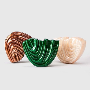 Close-up of shell-shaped acrylic clutches with iridescent mother-of-pearl texture