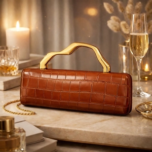 Brown crocodile leather evening clutch with stylish gold wave handle and chain strap
