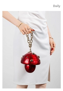 Detail of red marble acrylic mushroom bag with gold studs and chunky chain handle