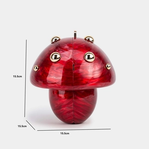 Detail view of red and white mushroom acrylic evening bag with dimensions 15.5cm