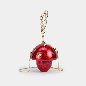 Detail view of red mushroom acrylic clutch with marble texture and gold chain strap