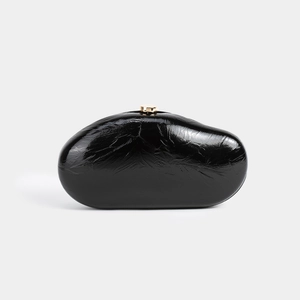 Sleek black patent PU leather pebble-shaped clutch bag with elegant gold metal cylinder clasp
