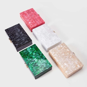 Detail of five acrylic clutches showing marble texture and gold metal clasps