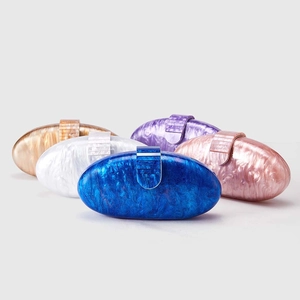 Multiple colorful acrylic shell evening clutches with marble texture and metal clasps
