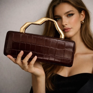 Deep brown crocodile pattern evening clutch bag with unique wavy gold metal handle