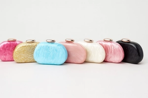 Detailed collection of acrylic shell clutches with marble textures and metallic pebble clasps