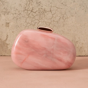 Macro detail of pink marble acrylic shell clutch bag with rose gold metallic clasp