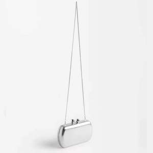 Sleek silver metallic hard shell evening clutch bag with slim chain shoulder strap