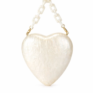Detail of heart-shaped pearlescent acrylic evening bag with white chunky chain strap