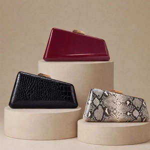 Detail of three textured evening clutch bags featuring snakeskin and faux leather textures