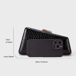 Detail of black crocodile texture clutch bag with dimensions and phone for scale