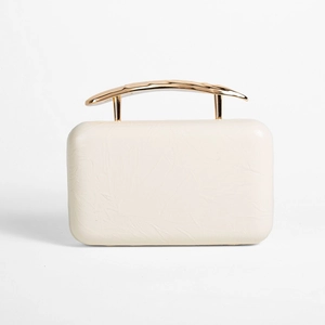 Detailed view of cream PU evening clutch with golden metal handle and pleated texture