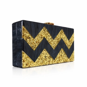 Elegant acrylic clutch bag featuring black and gold glitter zigzag striped patterns