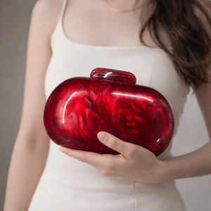 Detail of red marble acrylic clutch bag with glossy texture and elegant evening style