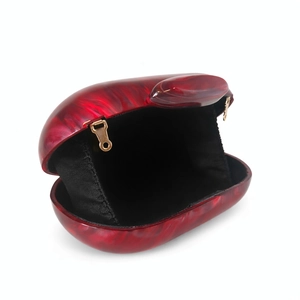 Detail view of the red marbled acrylic shell with golden clasp and black lining