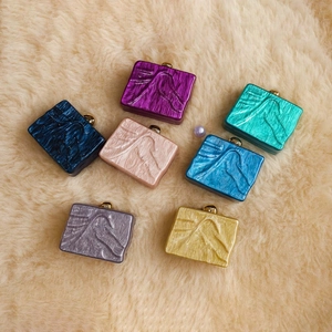 Detailed array of acrylic evening clutch bags in multiple vibrant marbled colors