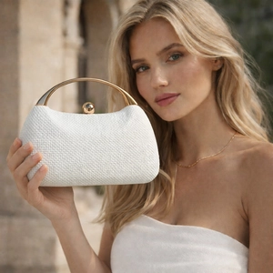 White woven evening clutch with golden circular handle and spherical metal clasp
