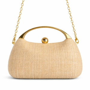 Detail of woven straw clutch with gold arched handle and metallic sphere clasp