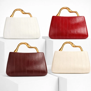 Detail of four colorful PU leather handbags with unique gold wavy metal handles and stitching