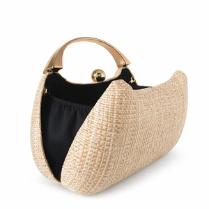 Detail of beige woven straw handbag with gold metal handle and black fabric lining