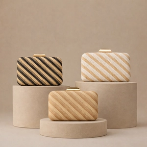Detail shot of textured woven evening clutch bags with golden metal snap closures