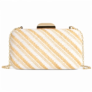 Detail view of a striped woven clutch bag with gold clasp and chain strap